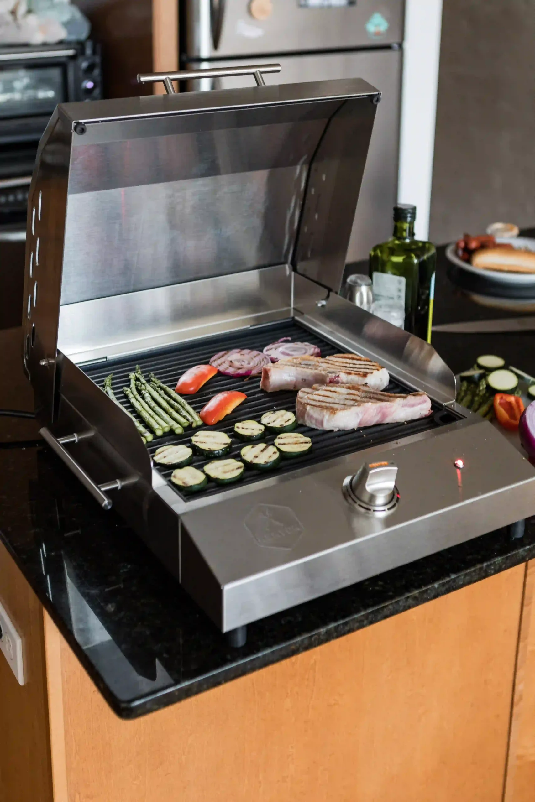 Food grilling on the Kenyon G2 Grill with vegetables and skewers on a smokeless indoor-outdoor grill