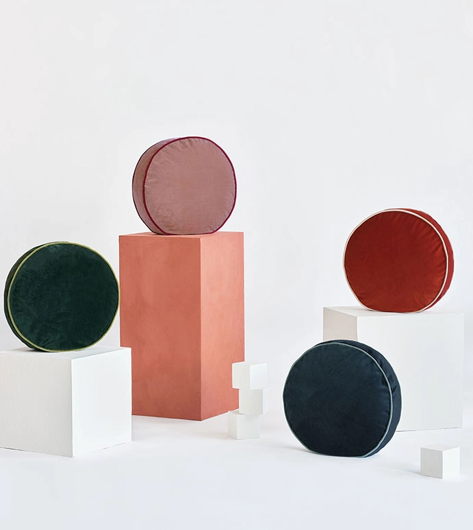Round accent pillows in different colors with accent trim on geometric shapes in white set
