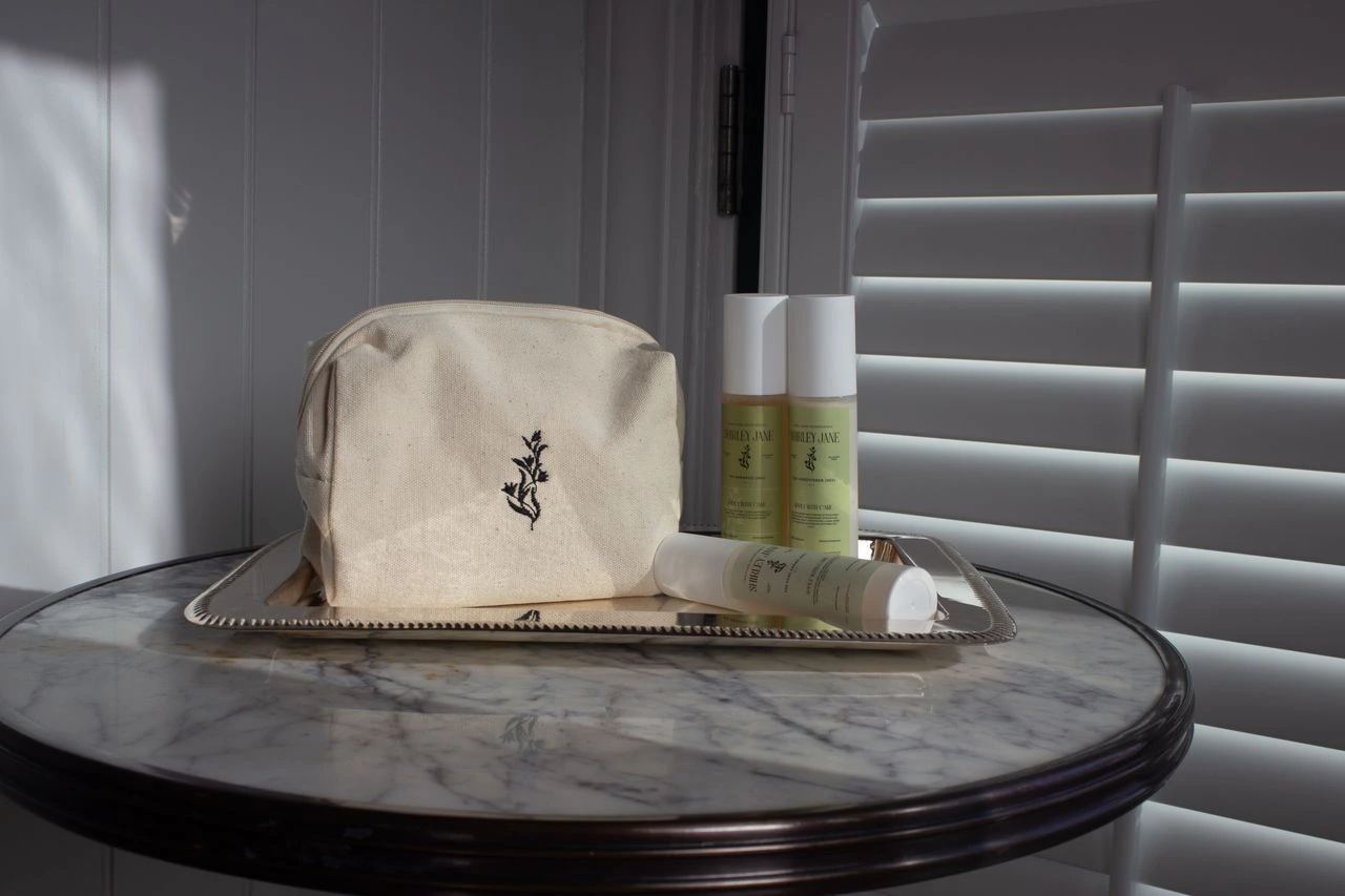 Shirley Jane Shampoo and Travel Bag on Table