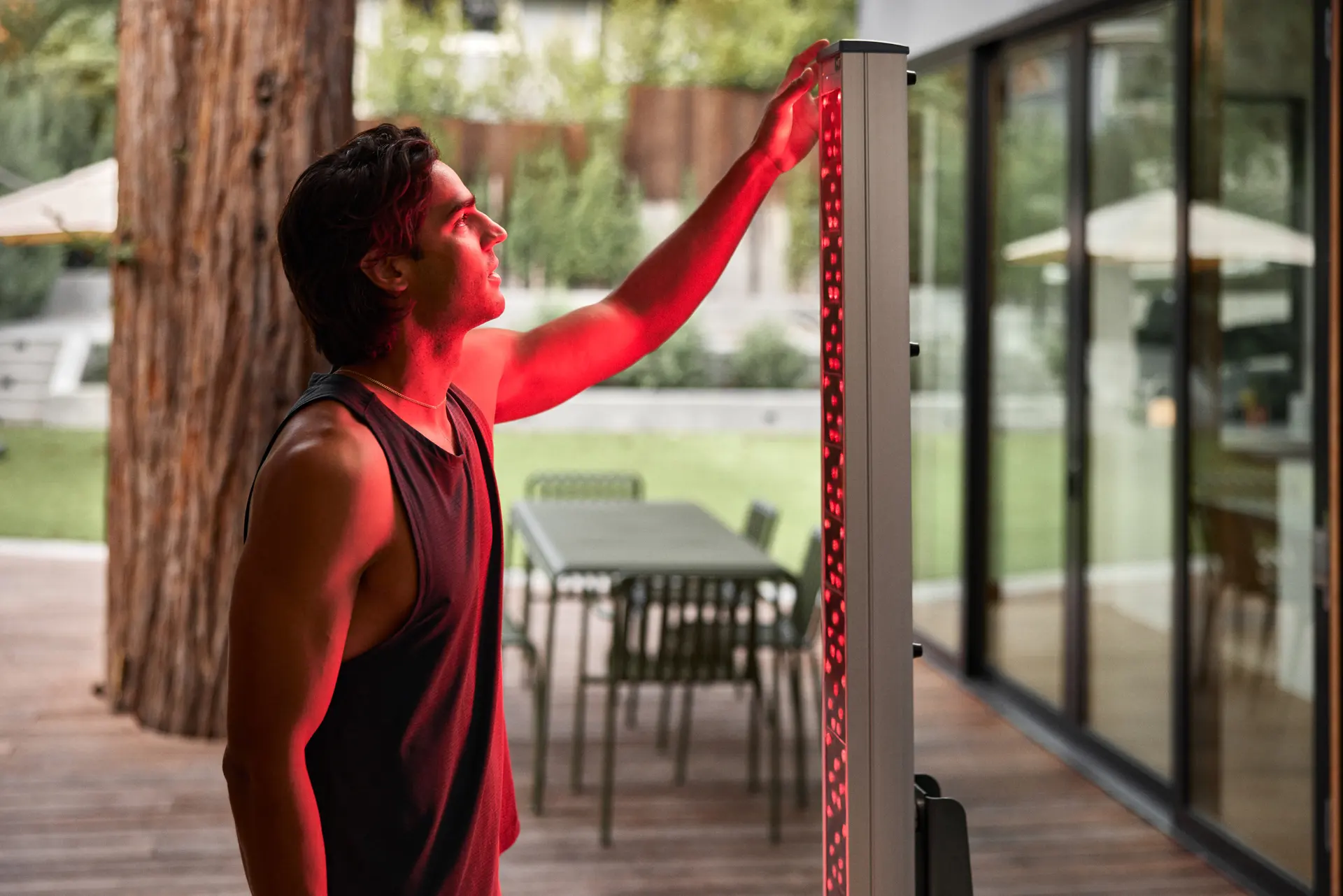man adjusting clearlight red light in outdoor gym